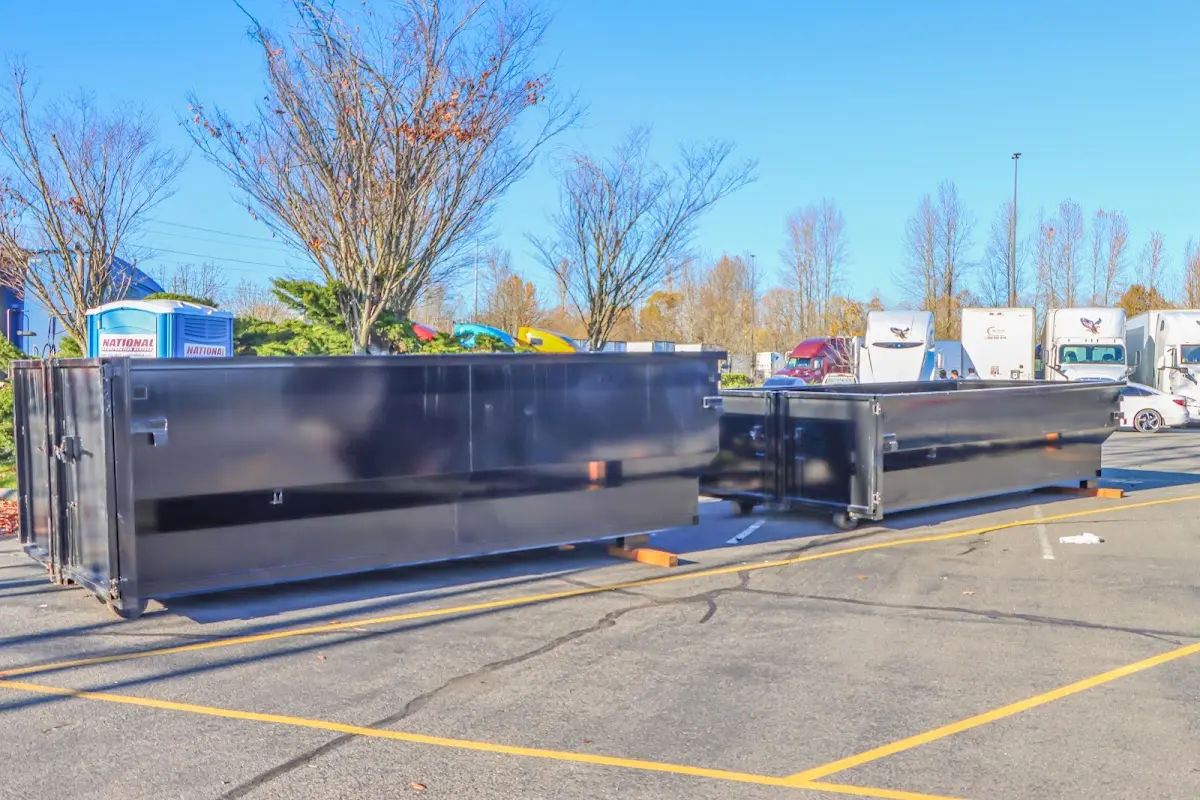 Professional dumpster rental service with roll-off container on residential driveway in Cresskill